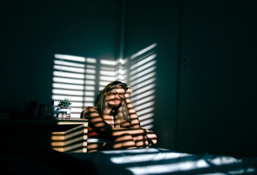 Photo of a girl sat in the dark